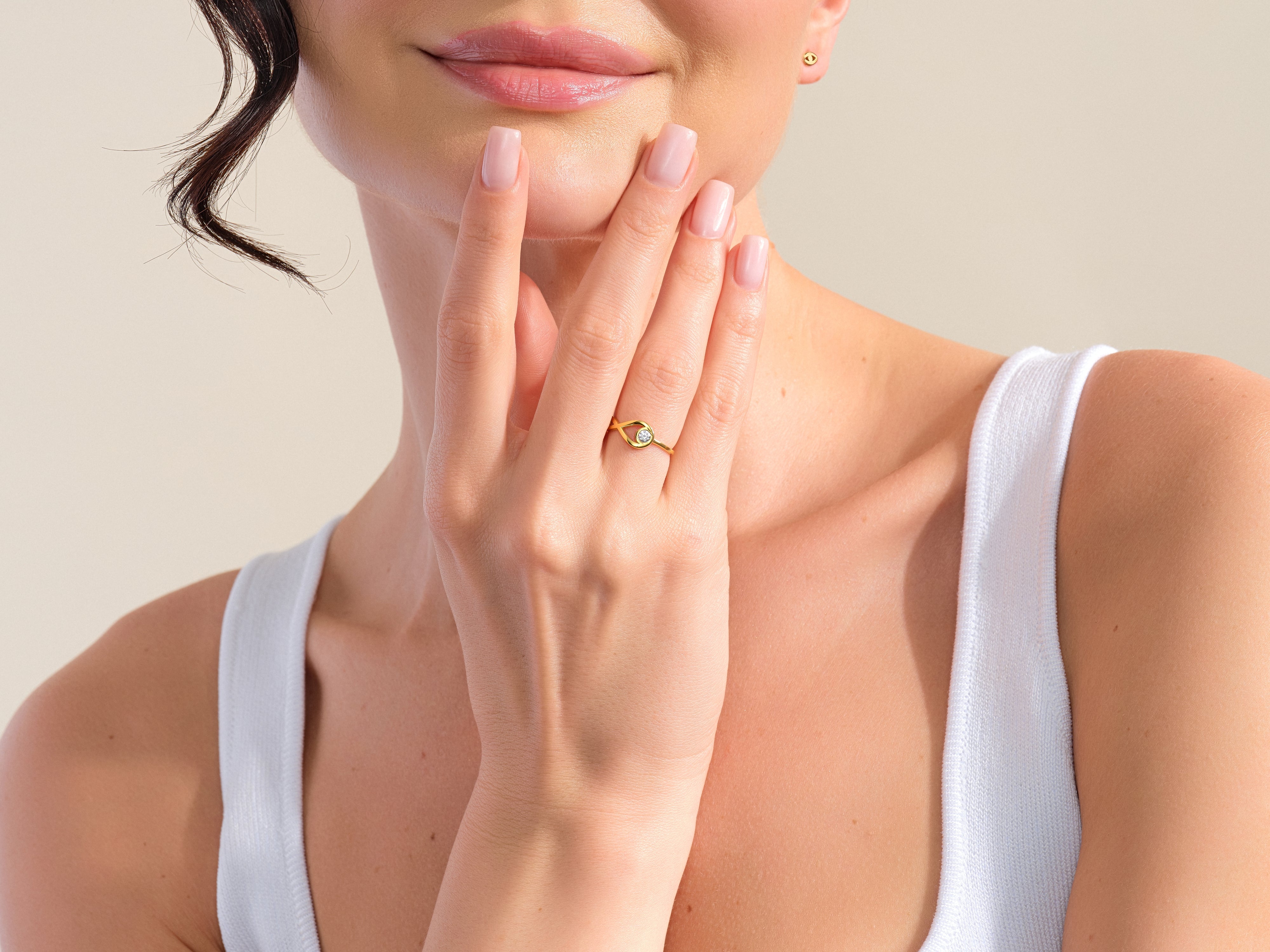 Gold ring with diamond on woman's hand, jewelry photography