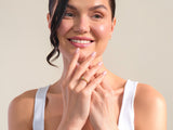 Woman wearing a gold diamond ring, showcasing fine jewelry