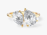 Two pear-shaped diamonds on a gold ring