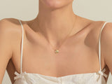 Gold ladybug necklace on a woman's neck, fine jewelry
