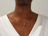 Diamond solitaire necklace on a woman's neck, fine jewelry