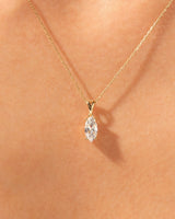 Gold necklace with marquise diamond pendant on skin