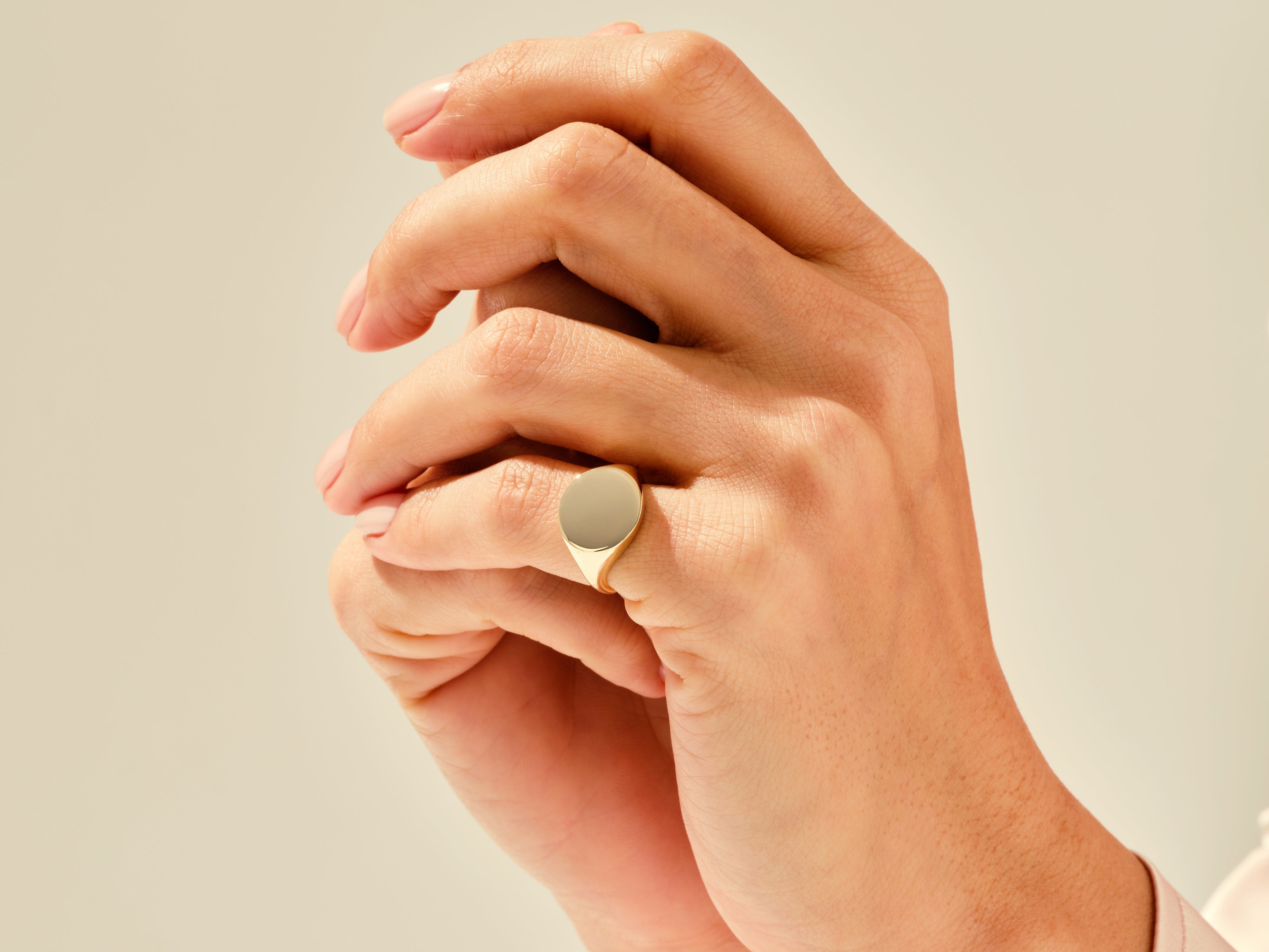 Gold signet ring on a hand, elegant jewelry for women