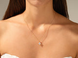 Gold necklace with diamond pendant on a woman's neck