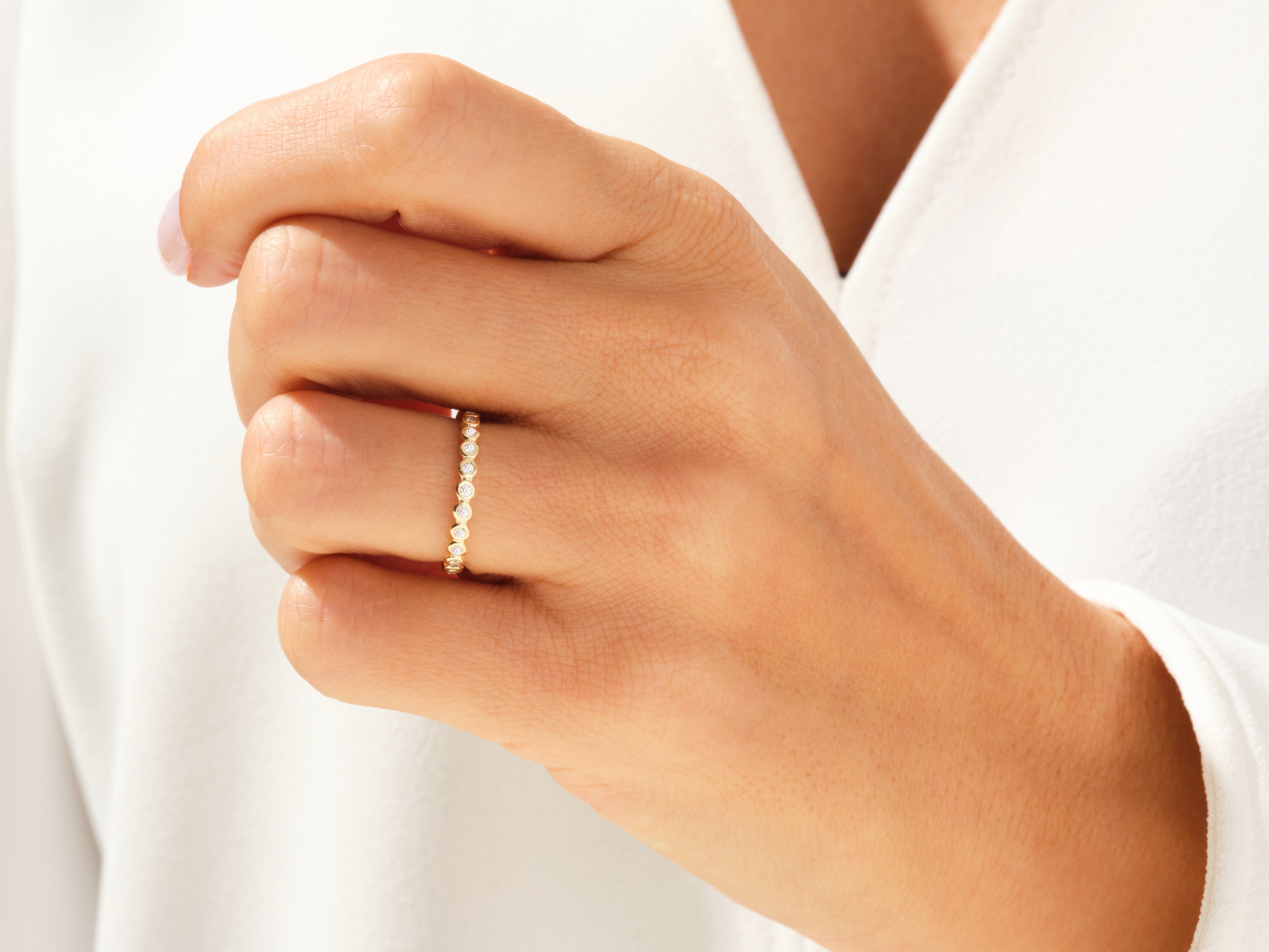 Diamond eternity band on a hand, fine jewelry