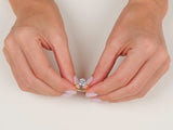 A video showcasing a hand wearing a yellow gold 4-prong solitaire oval cut moissanite engagement ring 