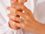 Diamond halo engagement ring on a woman's hand