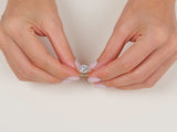  A video showcasing a hand wearing a yellow gold round cut moissanite halo engagement ring